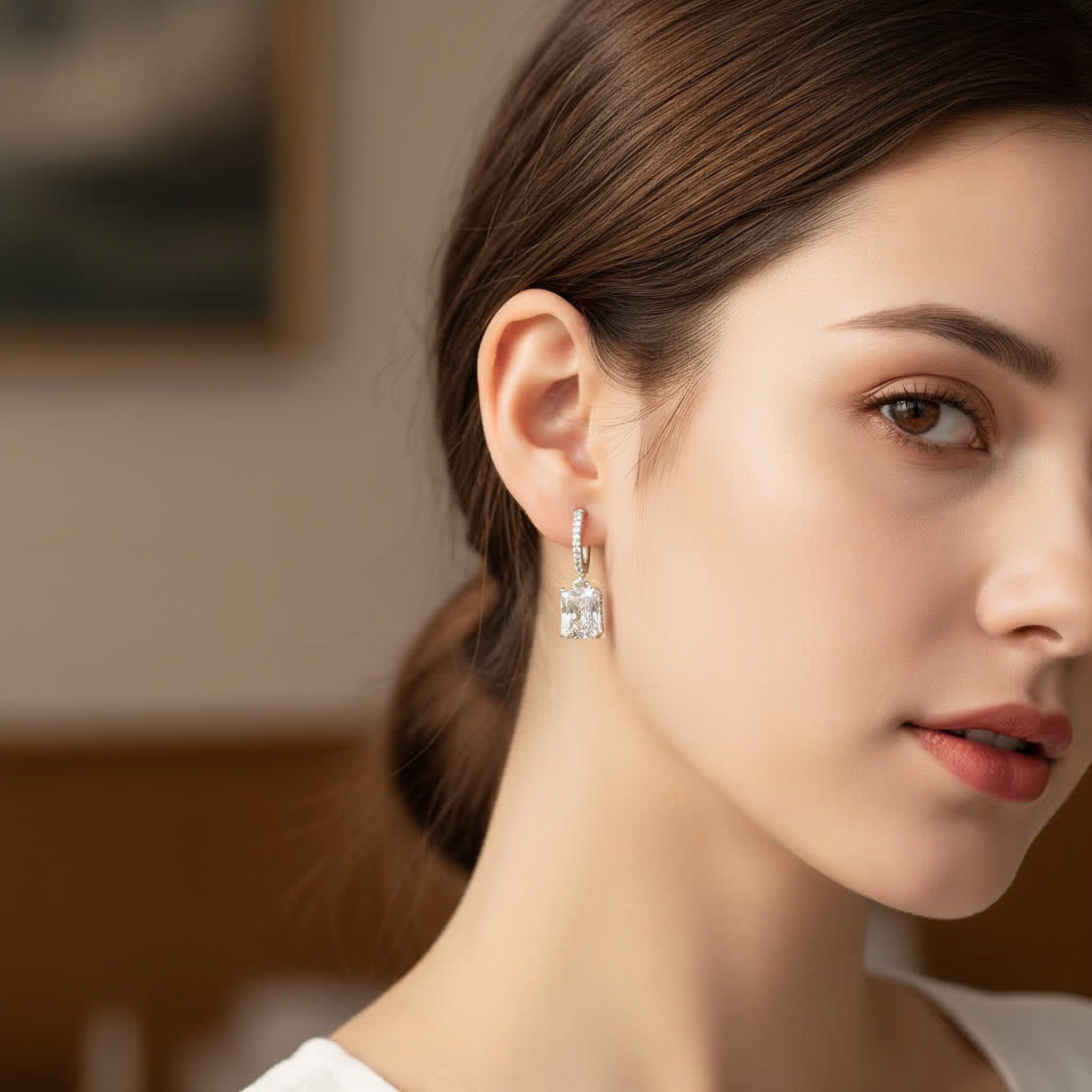 Close-up of a woman wearing elegant earrings with a blurred background