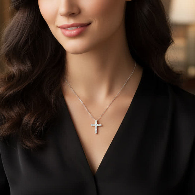 Woman wearing a black top and cross necklace in an indoor setting